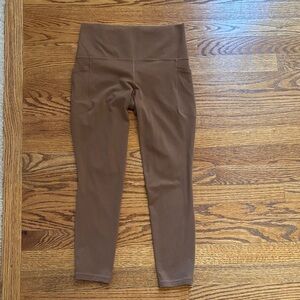 Athleta light brown Salutation Stash 7/8 Tights.  Size Small